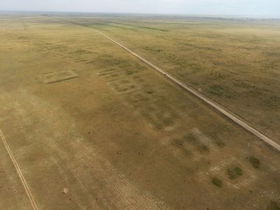 Aerial drone view of the Semiyarka archaeological site showing rectilinear earthworks and structured settlement layout